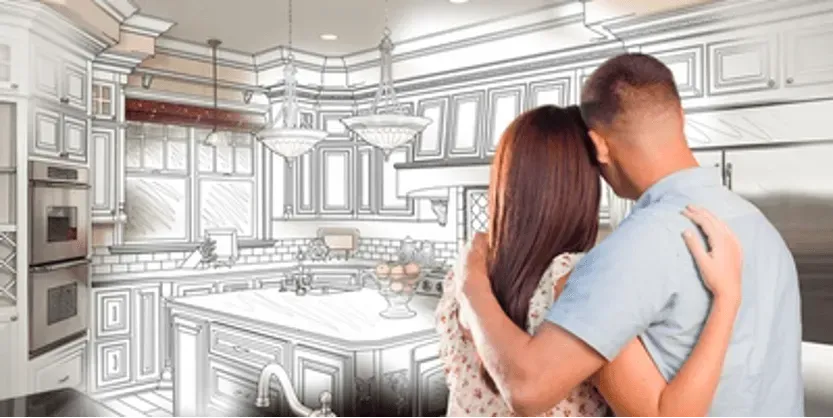 A man and a woman are looking at a drawing of a kitchen.