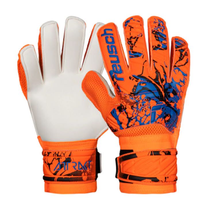 Par de guantes de portero Reusch naranjas y blancos, uno con la palma y el otro con el dorso pintados con un diseño de salpicaduras de pintura azul.