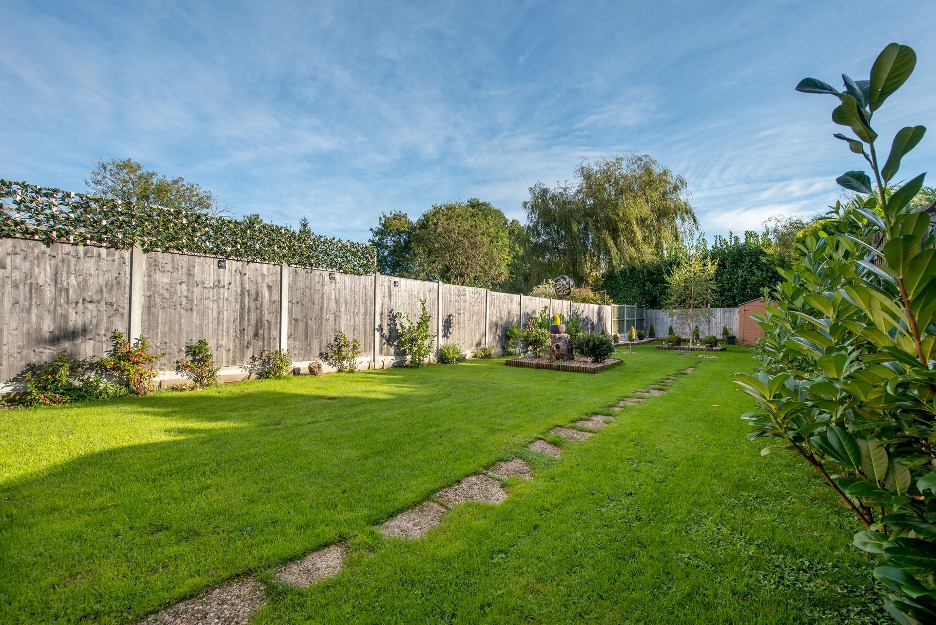 A Lush Green Backyard with A Wooden Fence and A Path - Kinston, NC - Garden Gator Landscape & Design A Lush Green Backyard with A Wooden Fence and A Path - Kinston, NC - Garden Gator Landscape & Design