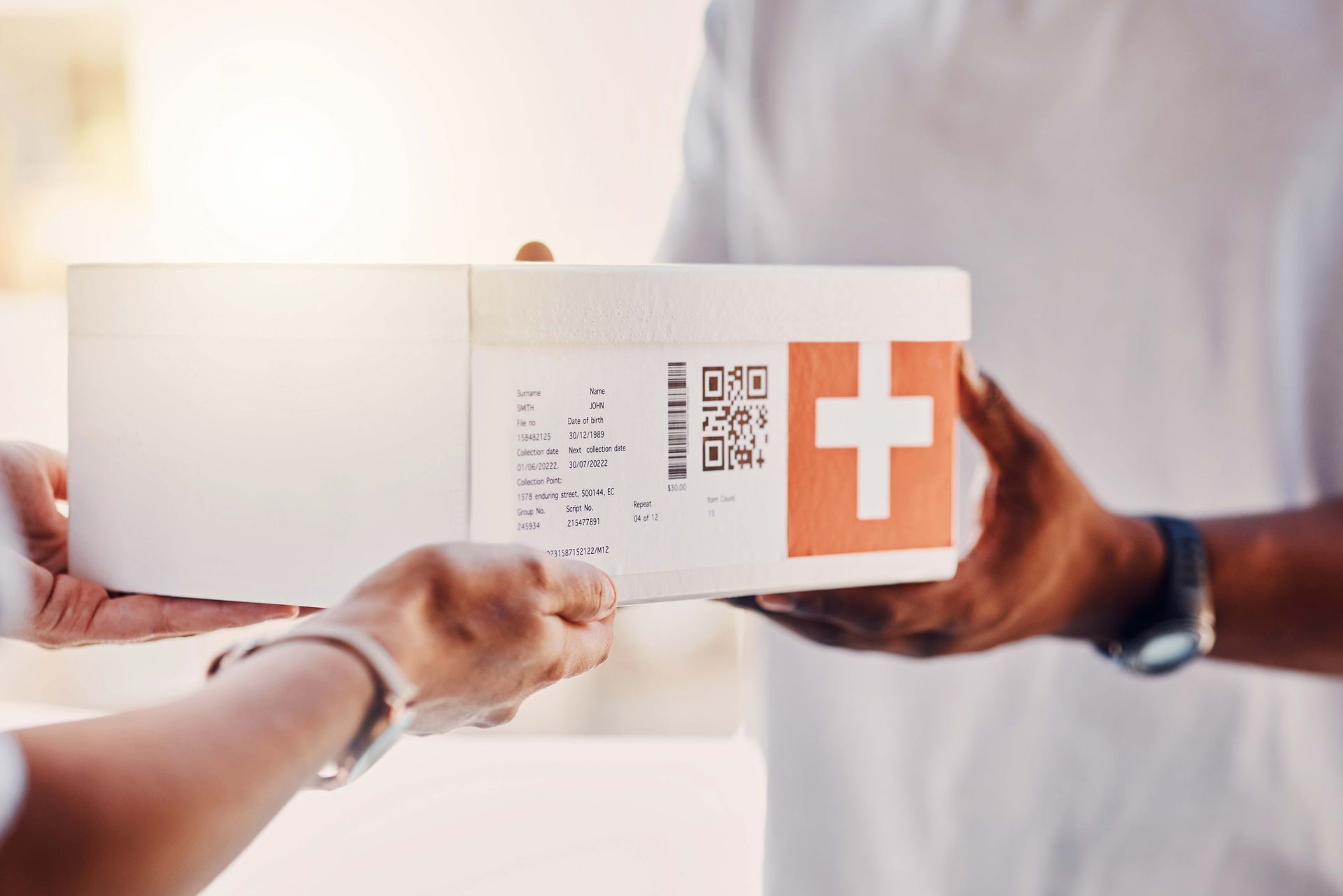 Close-up of a client receiving a box from a courier, showcasing a healthcare courier service.