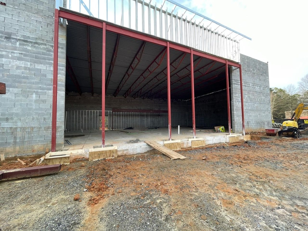 Commercial CMU block building under construction with steel columns and metal roof deck in Marietta Georgia