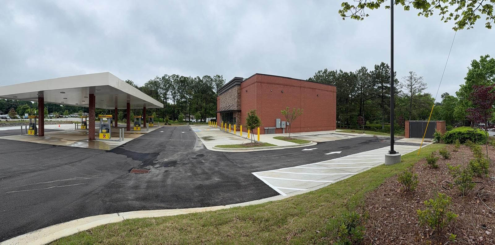 Completed commercial building with fuel canopy, brick exterior, and parking lot in Roswell Georgia