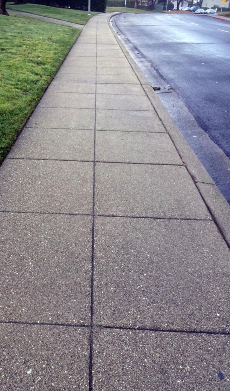 Finished concrete sidewalk with expansion joints and curb gutter in Woodstock Georgia