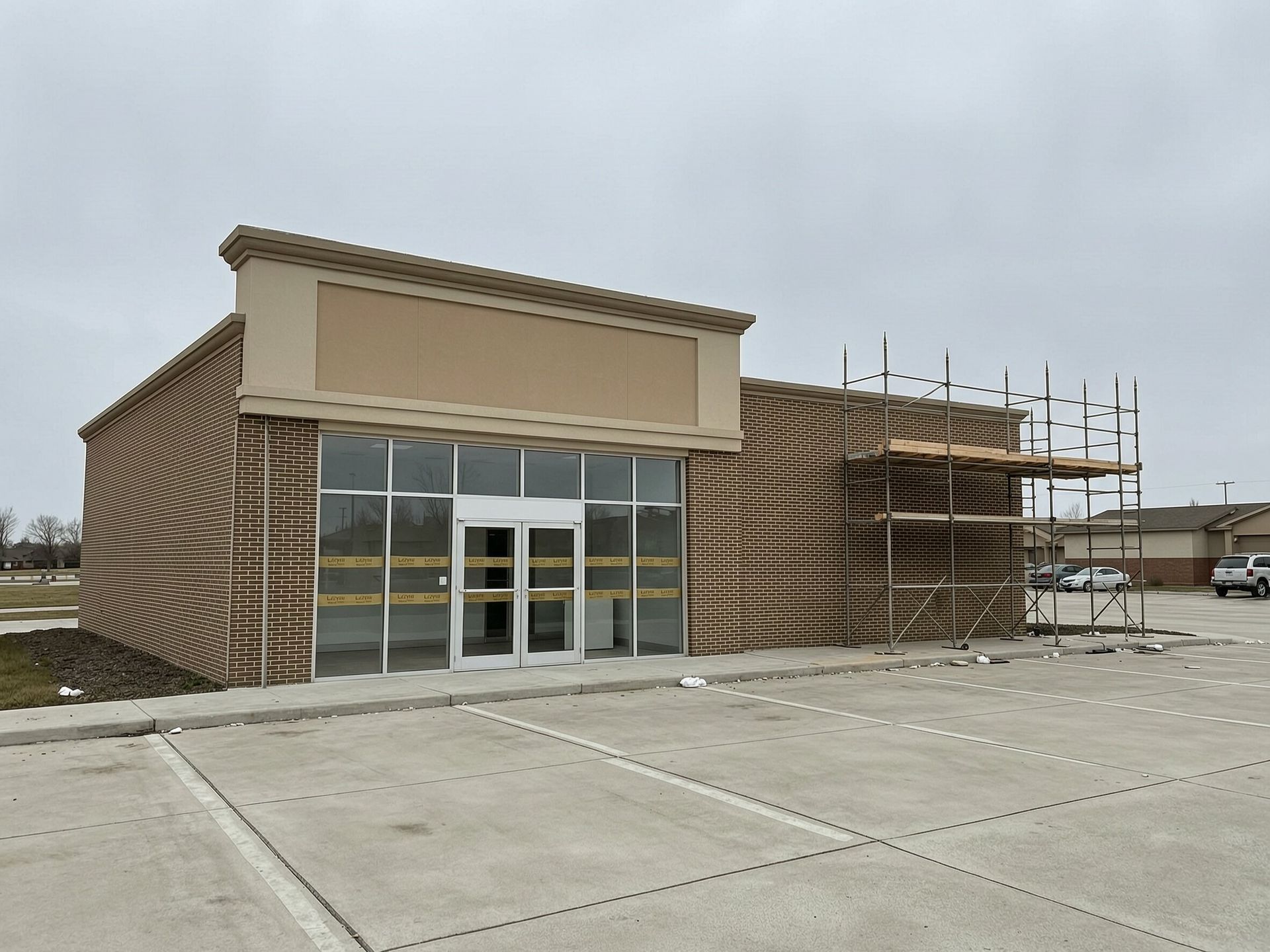 Commercial storefront exterior under construction with scaffolding, franchise buildout Georgia