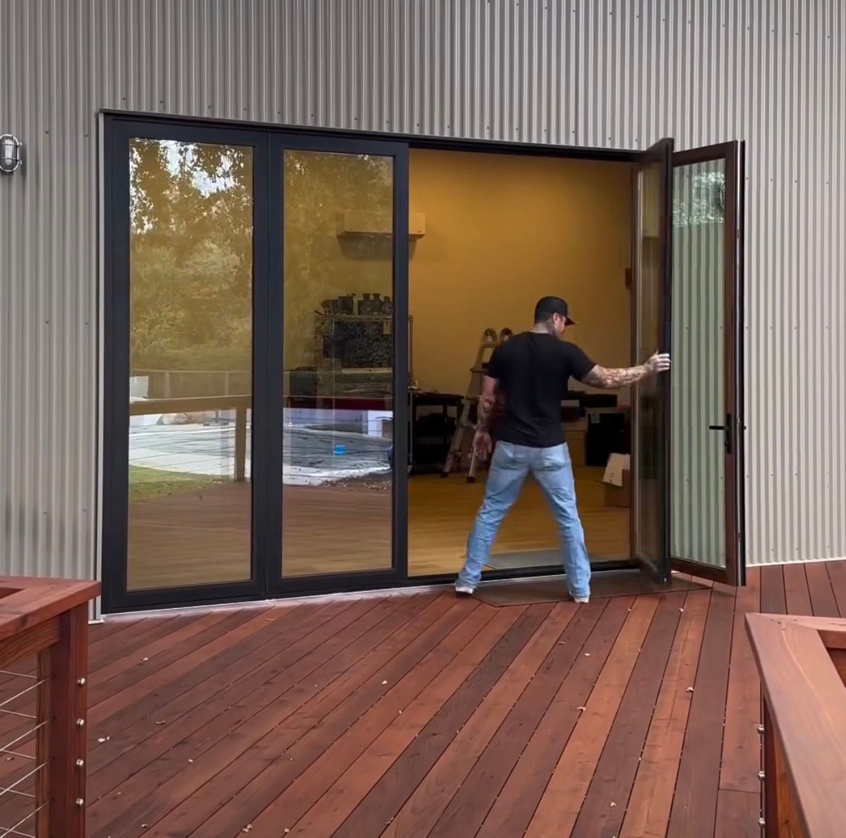 Residential hardwood deck with cable railing and matte black sliding glass door installation in Woodstock Georgia