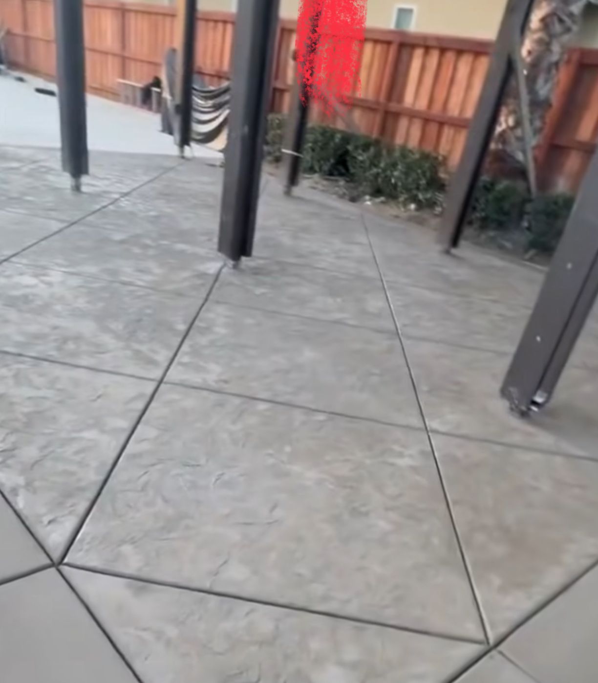 Completed stamped concrete patio with geometric texture pattern and pergola by concrete contractor serving Marietta and Cobb County GA