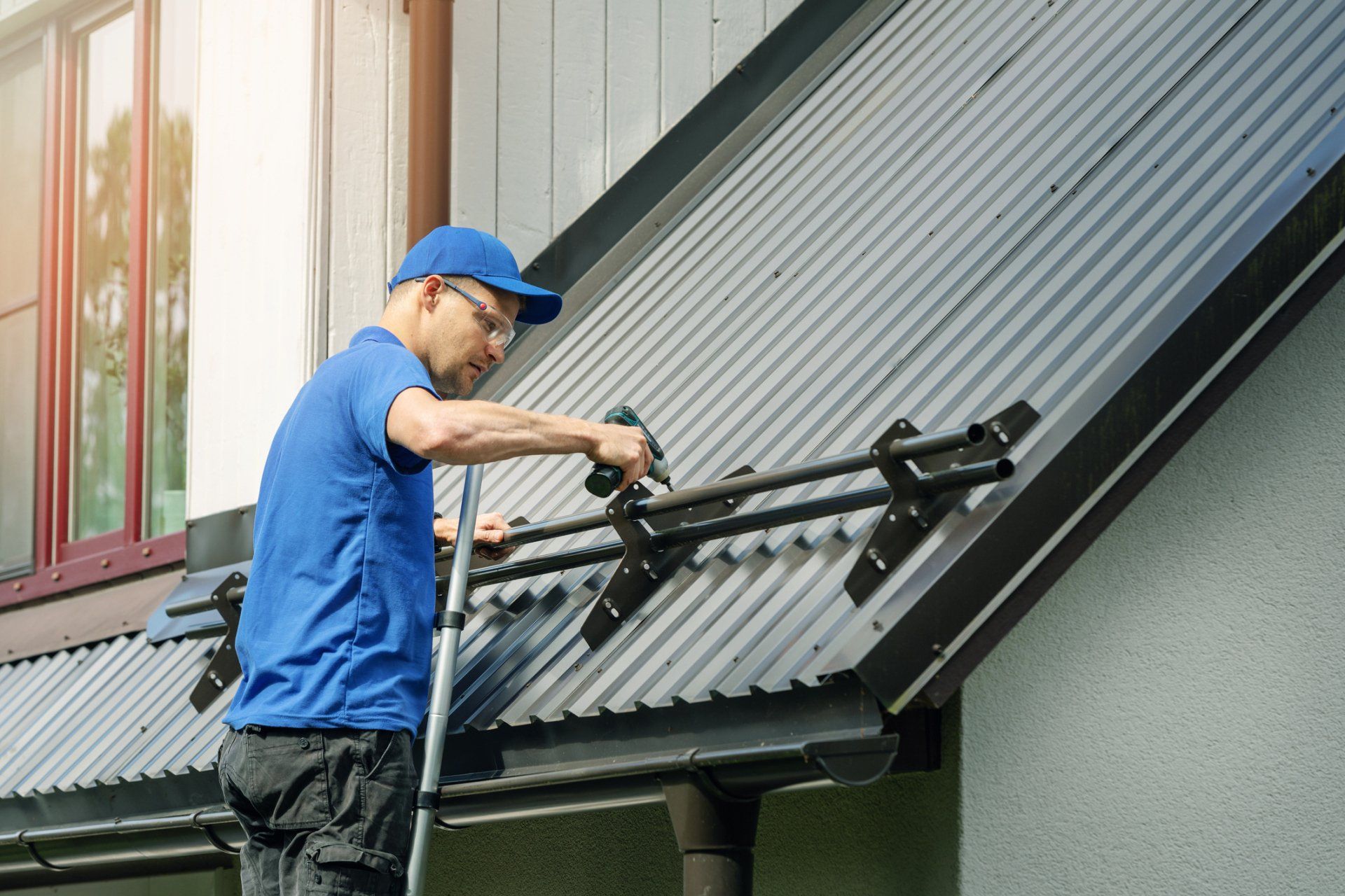 Worker Adding Metal On Roof — Yuba City, CA — Action Roofing Service Inc.