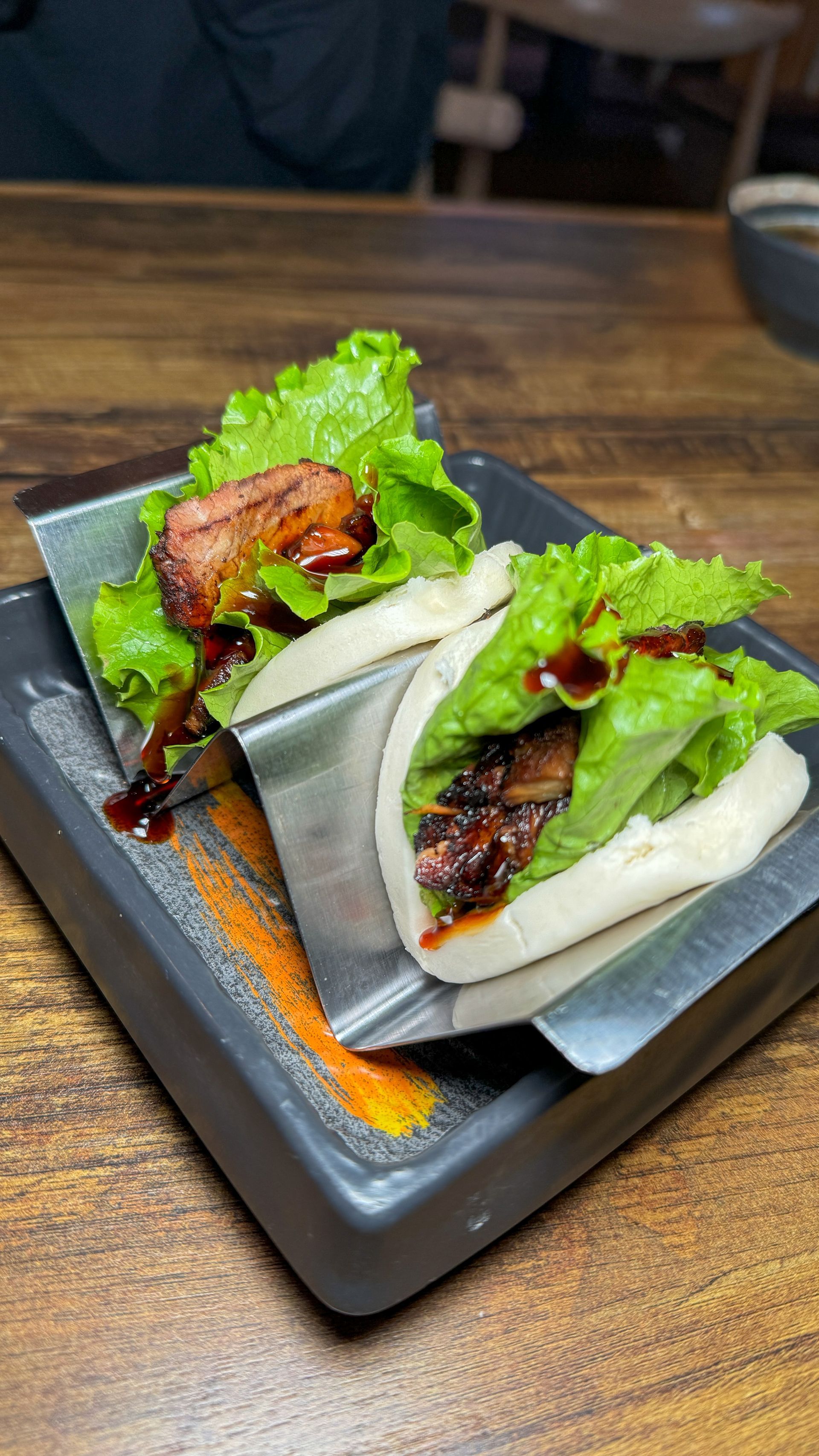A close up of a plate of food on a wooden table.