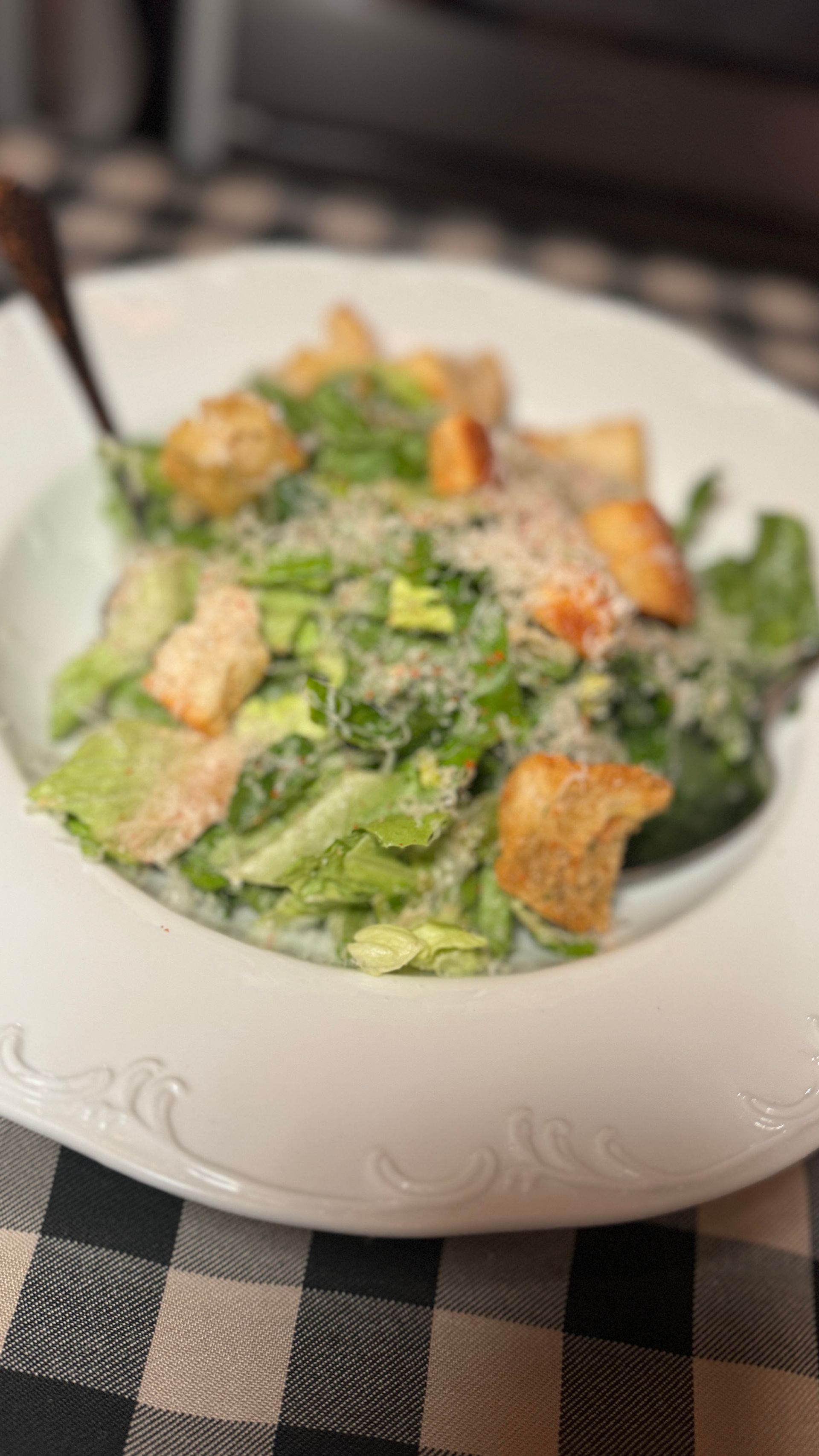 A close up of a plate of food with a spoon on a table.