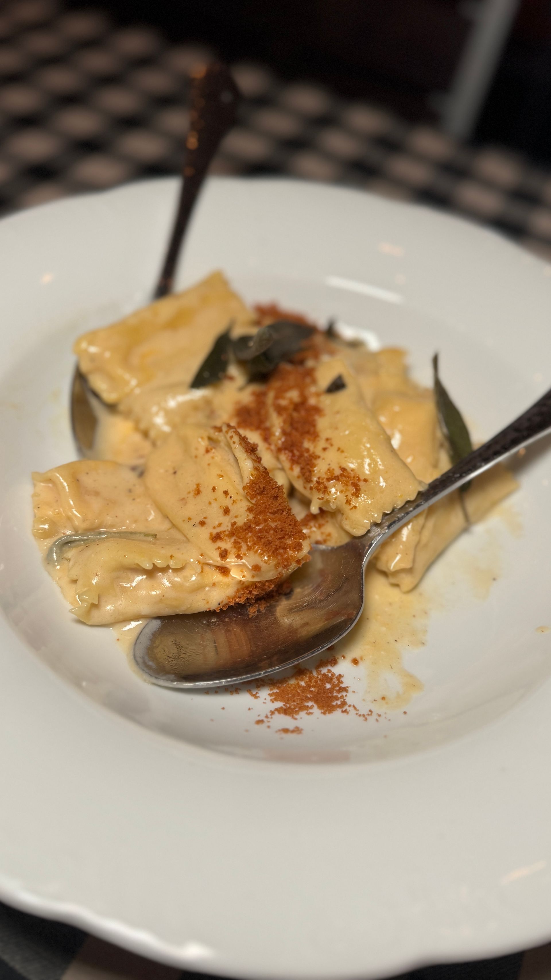 A close up of a plate of food with a spoon in it.