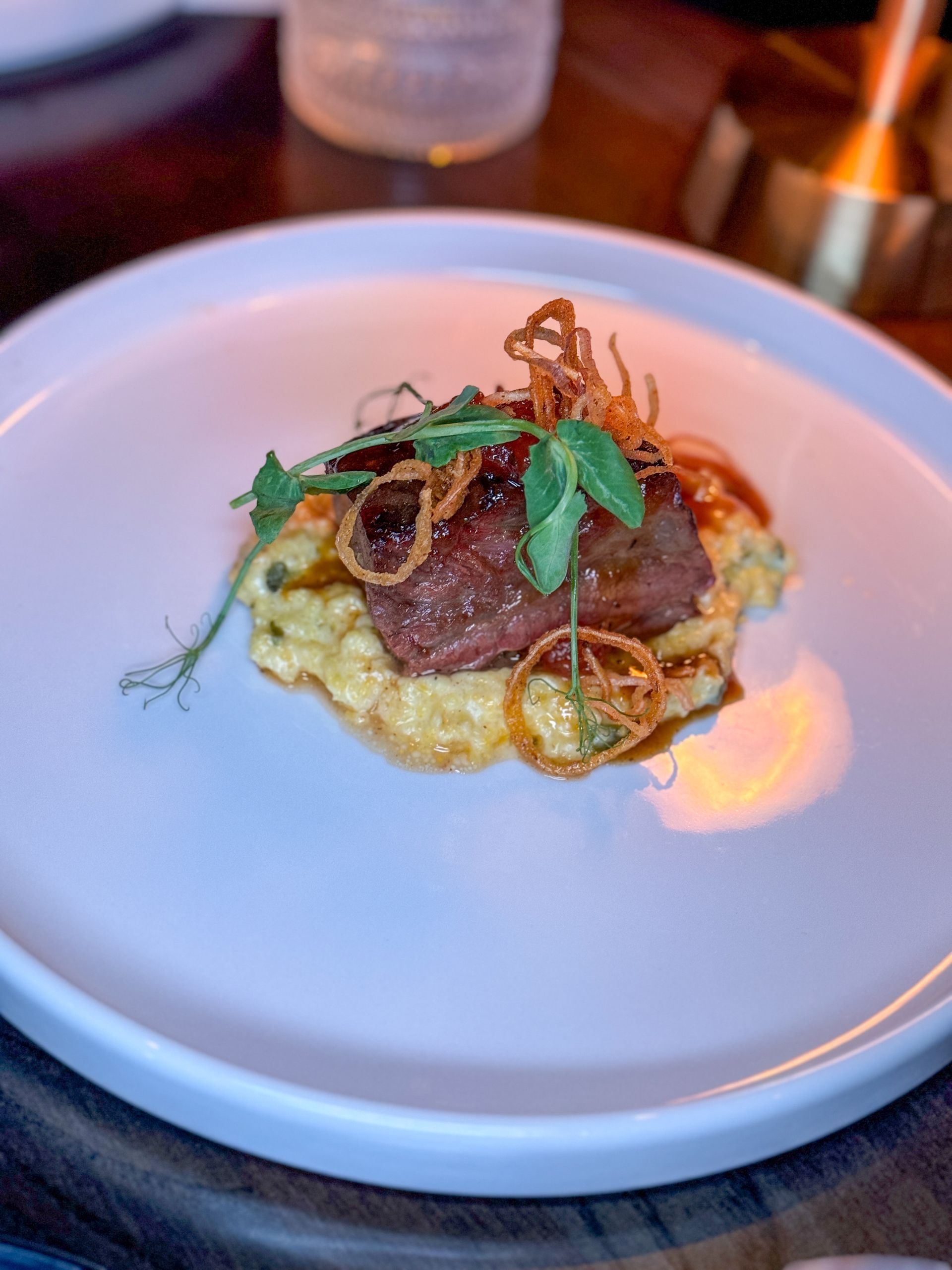 A close up of a plate of short rib on a table.