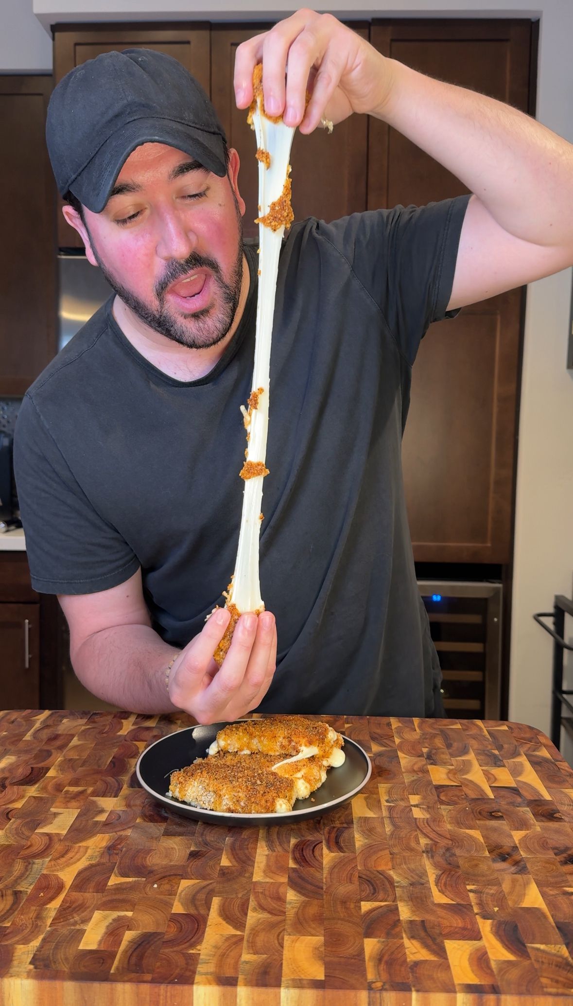 A bowl of salsa and tortilla chips on a wooden cutting board.