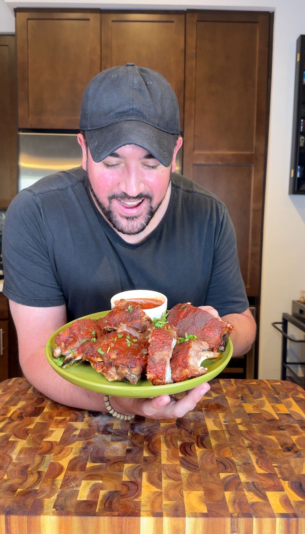 A bowl of salsa and tortilla chips on a wooden cutting board.
