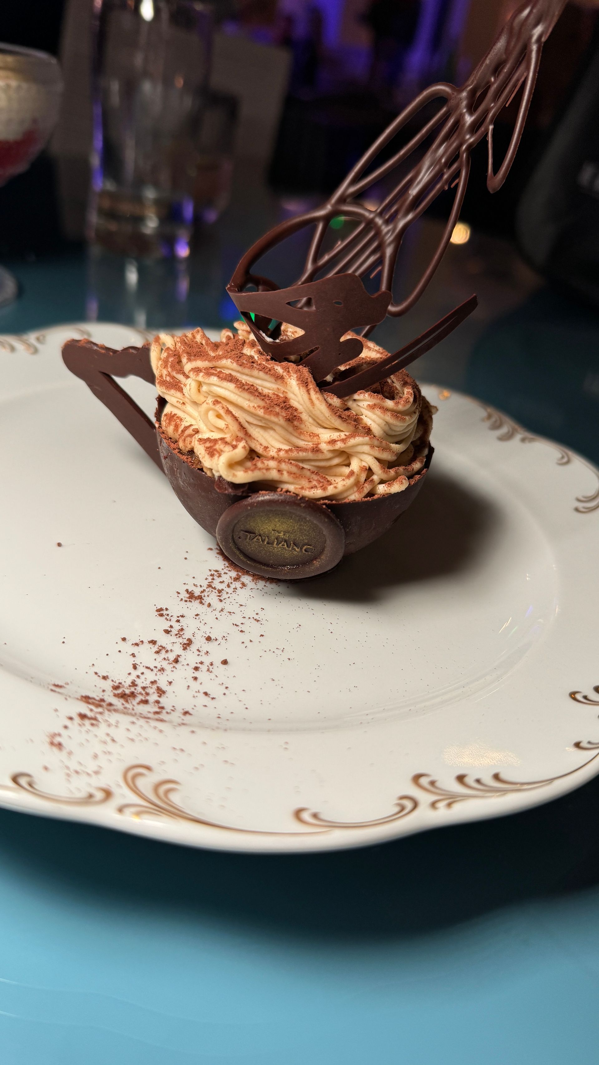 A white plate topped with a dessert in the shape of a wheelbarrow.