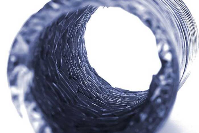 View inside a dark, textured tube with a bright, white opening at the end.