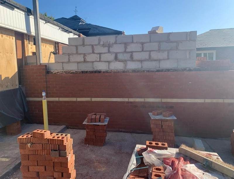 Boundary and retaining wall under construction in brick and block