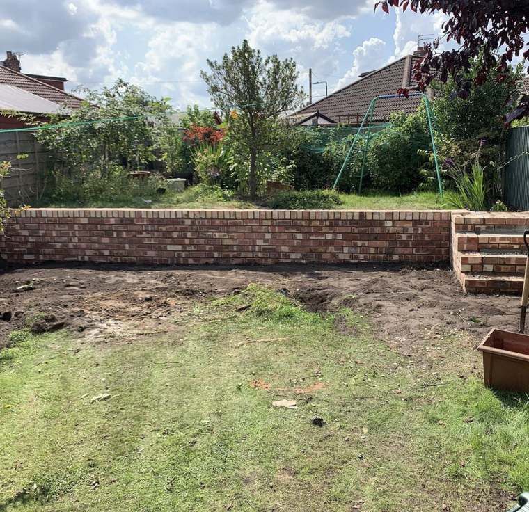 Newly built retaining wall with matching brick steps