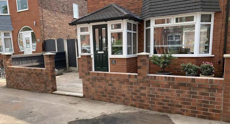 Finished red brick front garden boundary wall with porch