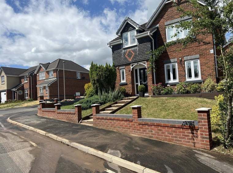 Finished retaining wall and steps on a sloped front garden