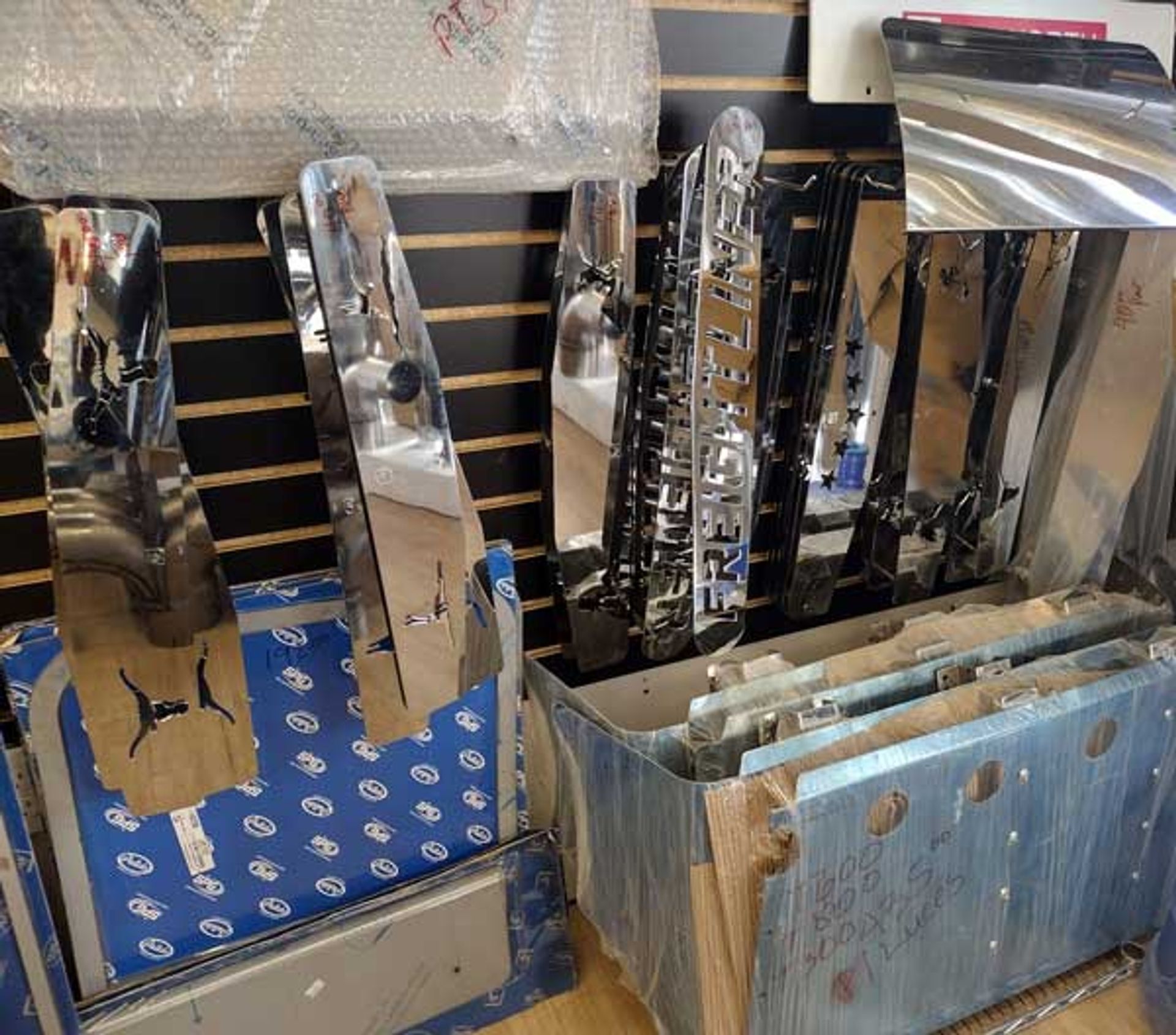 A bunch of stainless steel parts are sitting on a table