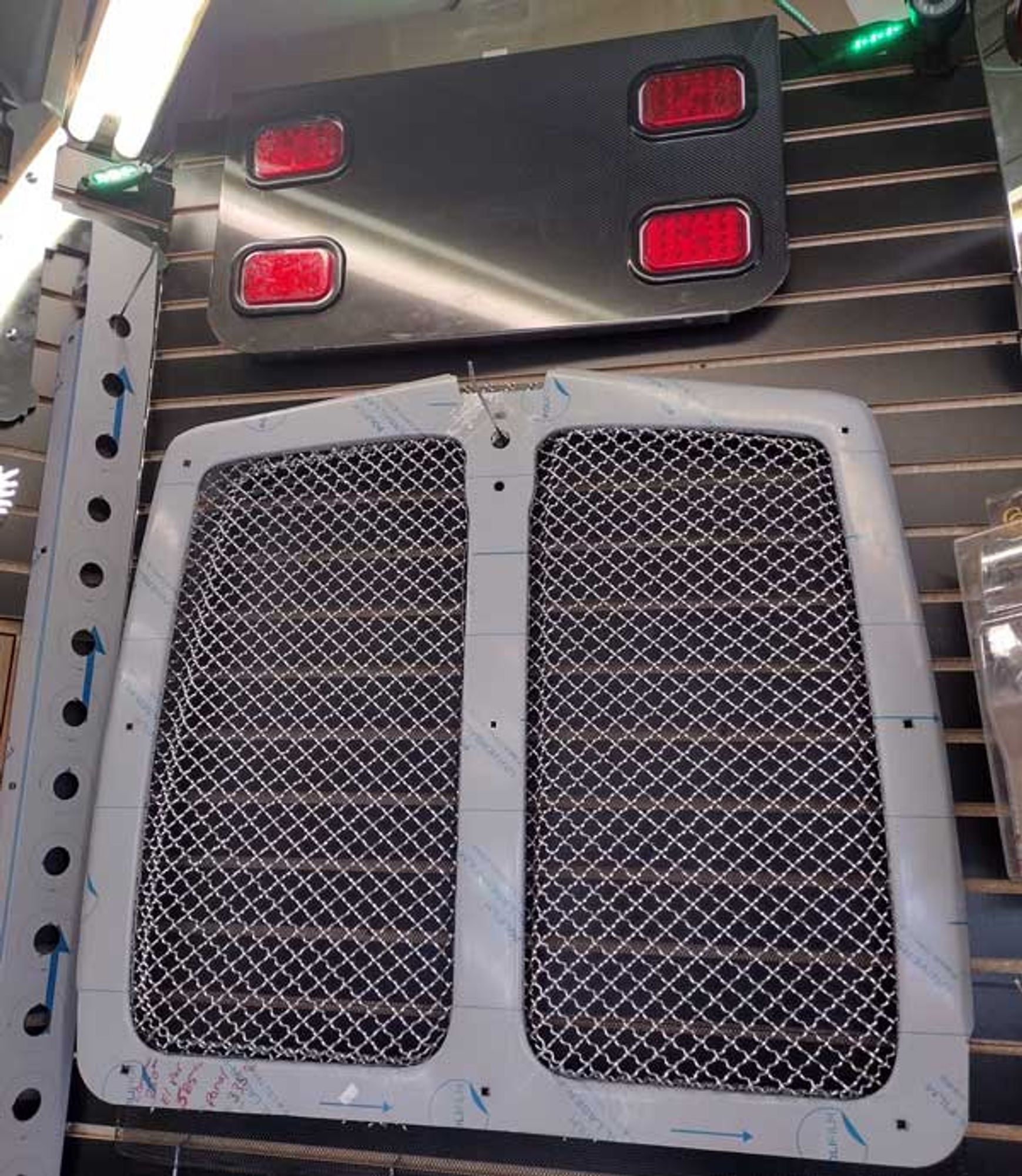 A stainless steel grille with two red lights on it
