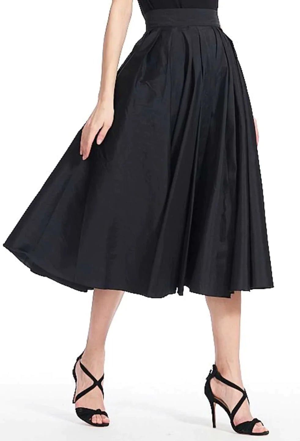 A woman is wearing a black skirt and heels.