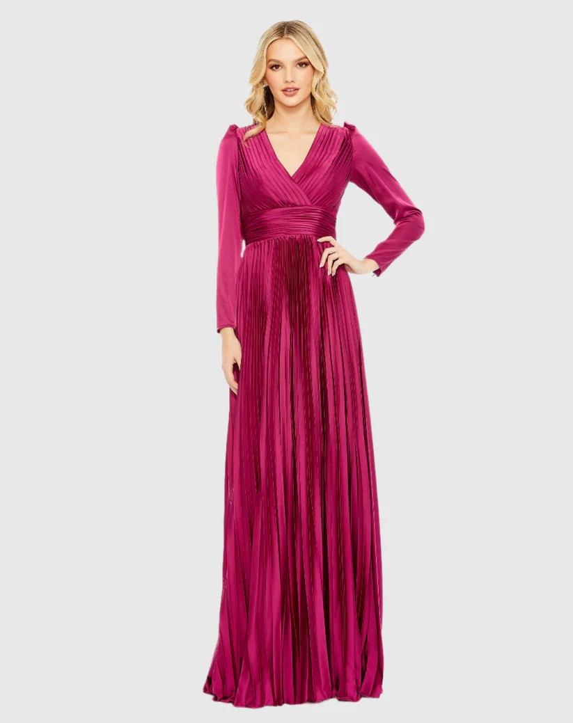 A woman is wearing a long pink dress with long sleeves