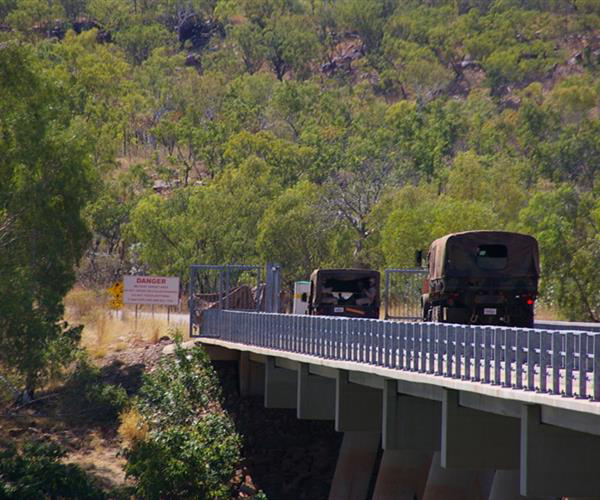 Trucks Driving Over a Bridge — Frontier Cement Supplies In East Arm, NT