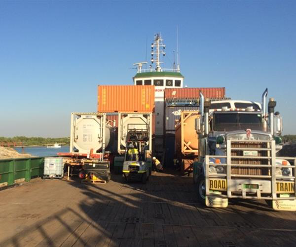 A Row Of Military Vehicles Are Driving On A Bridge — Frontier Cement Supplies In East Arm, NT