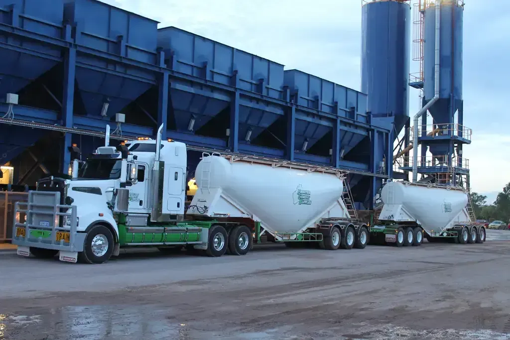 A Forklift Is Carrying A Bunch Of Bags On A Dirt Road — Frontier Cement Supplies In East Arm, NT
