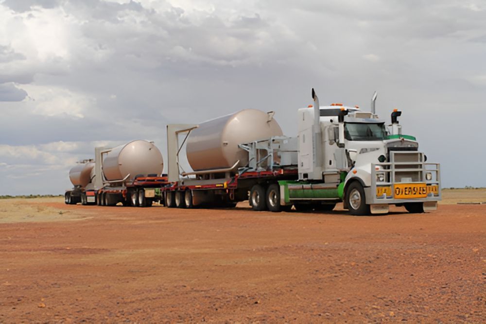A White Semi Truck With A Yellow License Plate — Frontier Cement Supplies In Kununurra, NT