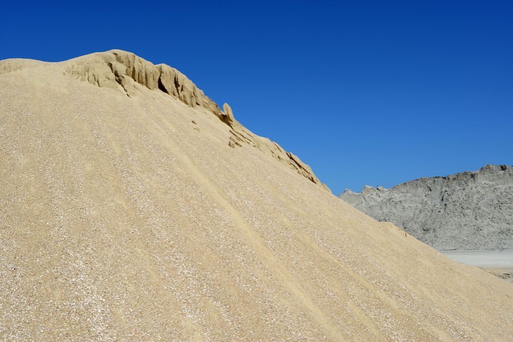 A Large Pile Of Sand Against A Blue Sky — Frontier Cement Supplies In East Arm, NT