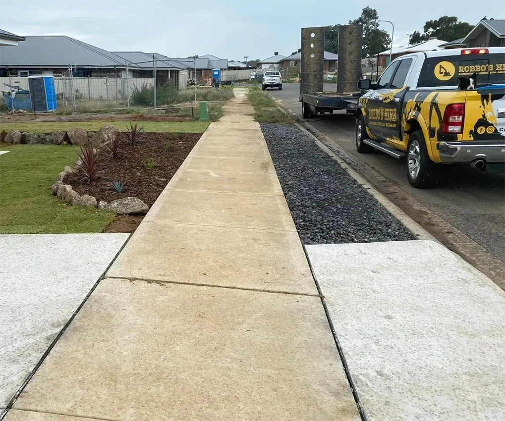A Concrete Driveway and Footpath with a Truck and Trailer — Robbo's Hire In Wodonga, VIC