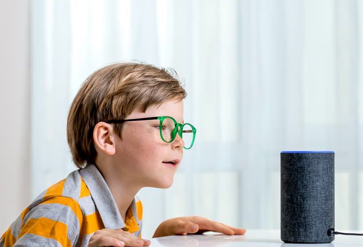 Young Boy Is Looking At An Amazon Echo Speaker — Future Tech Electronics and Computers in Salamander Bay, NSW