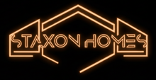 Neon orange “STAXON HOMES” logo outlined like a house on a black background