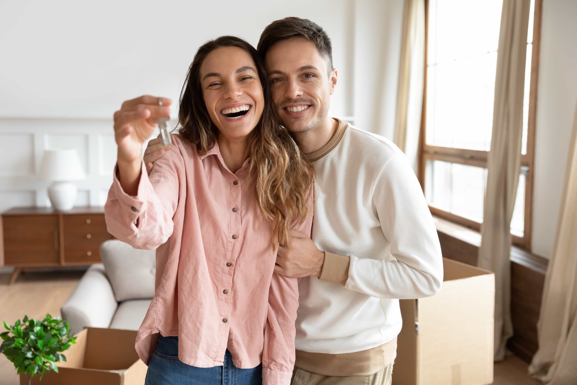 Happy Couple Holding Key To New Home