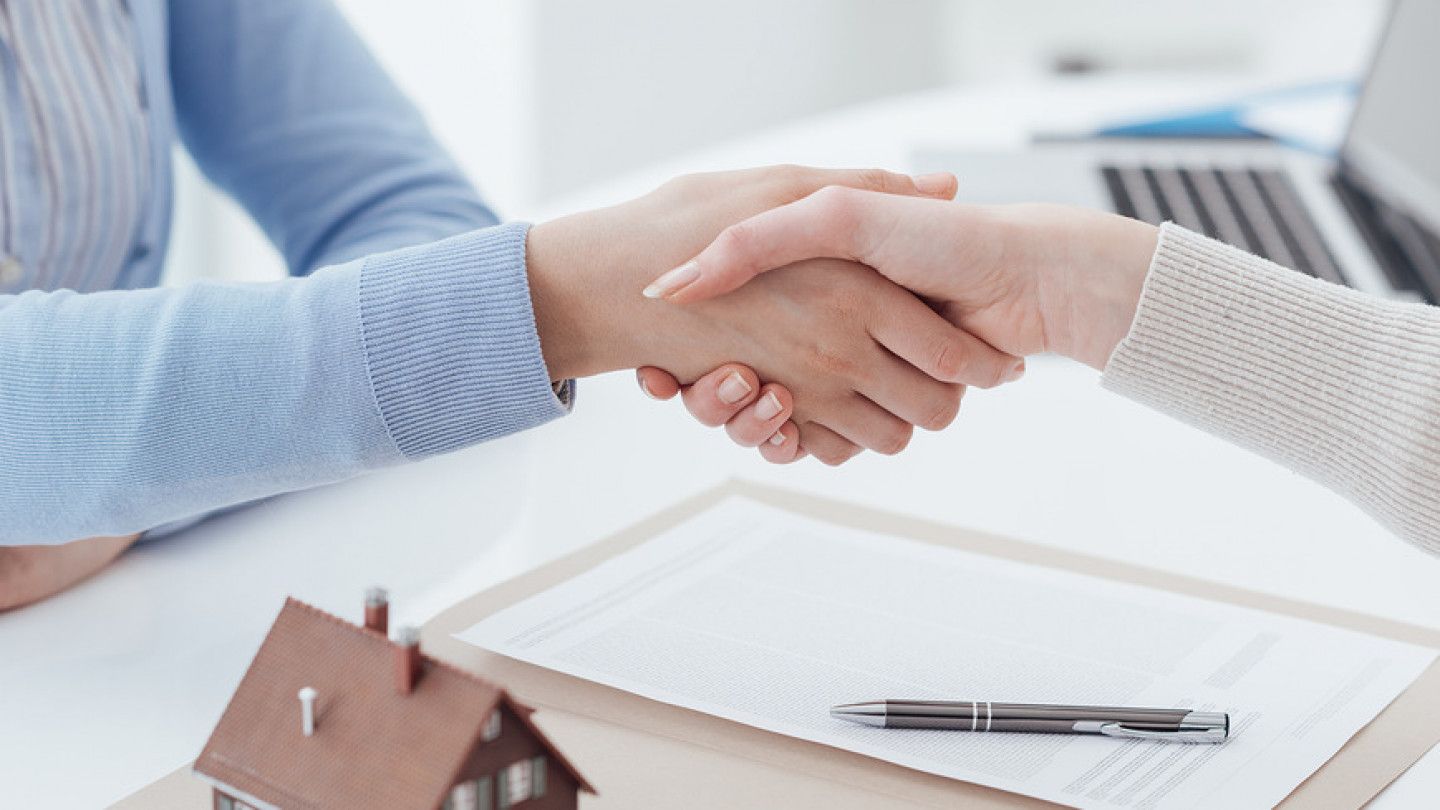 Financial advisor and customer meeting in the office and shaking hands