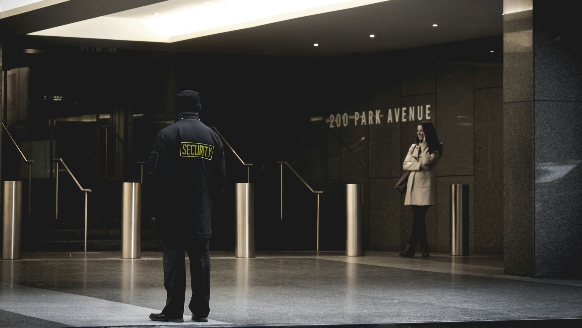 A man standing in front of a building that says 290 park avenue