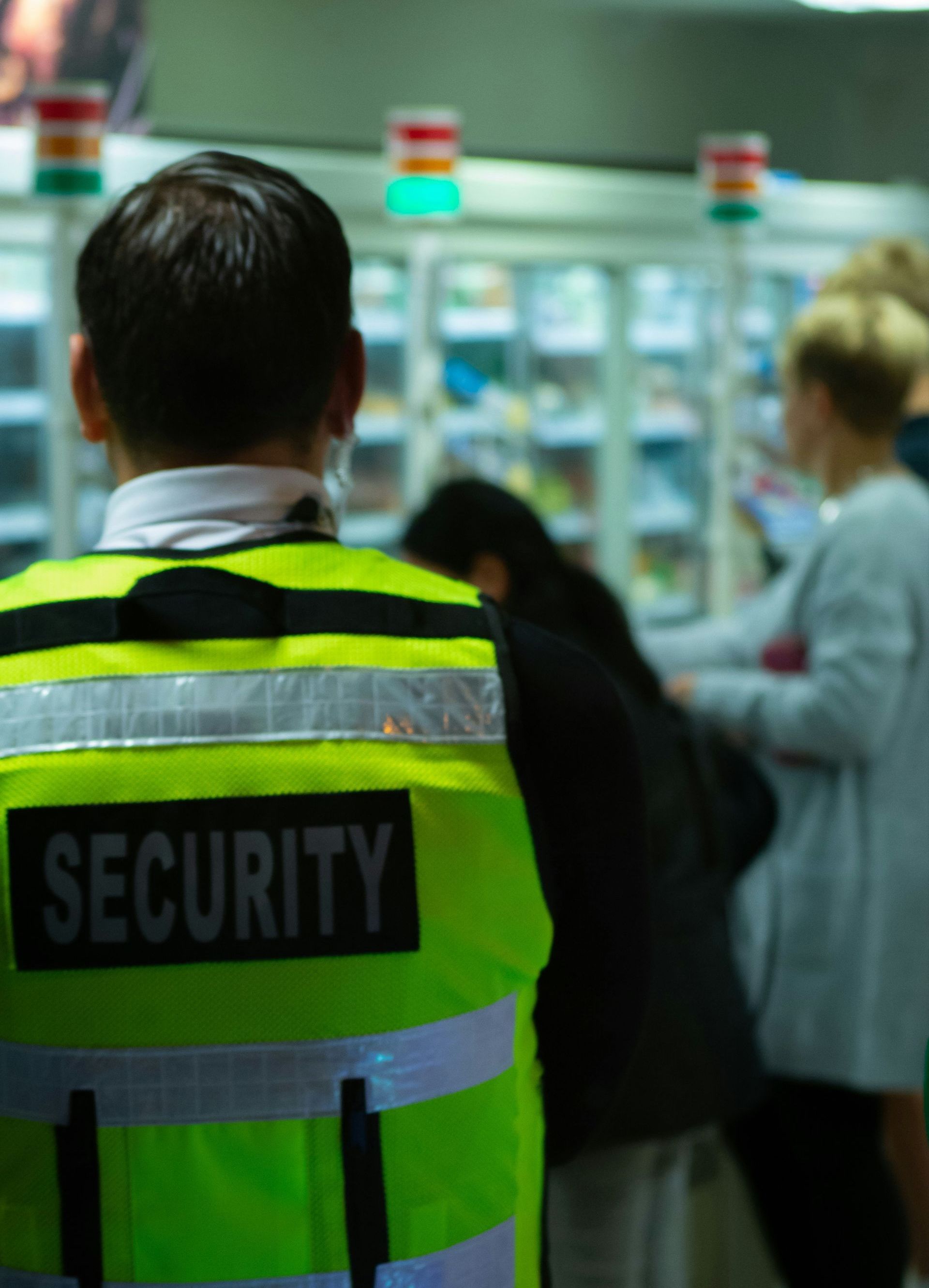 A man wearing a yellow vest with the word security on it
