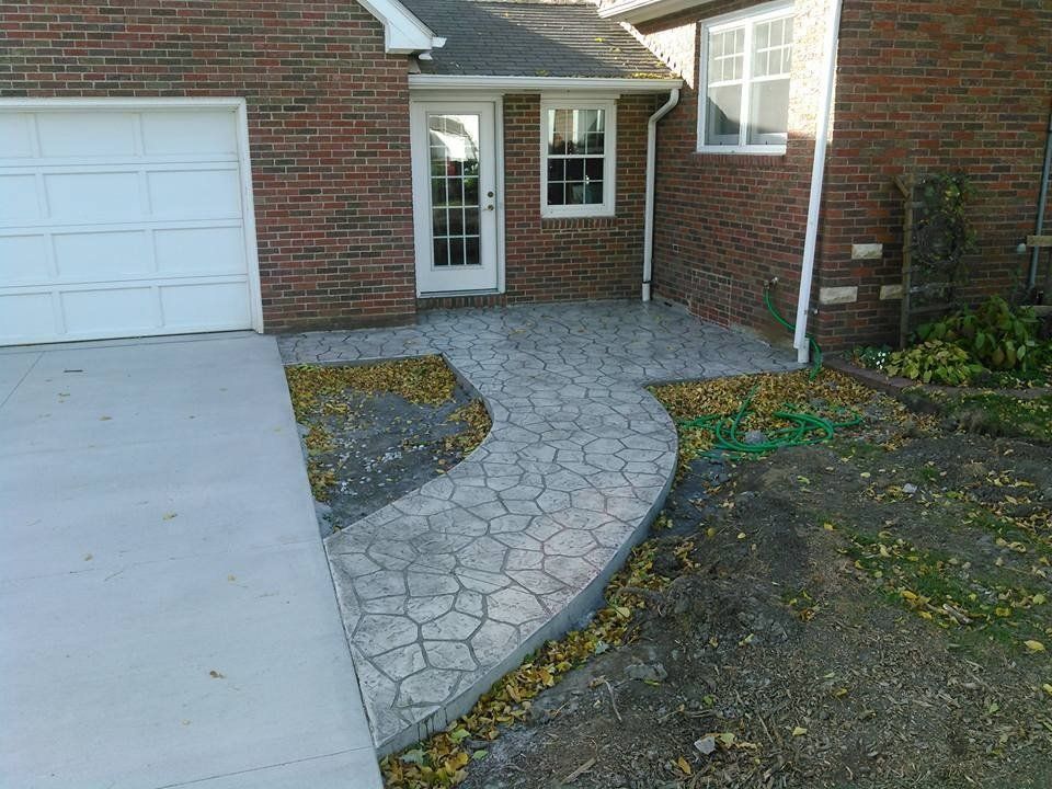 House with stone walkway that has intricate pattern — Cedar Rapids, IA — Earthworks Concrete