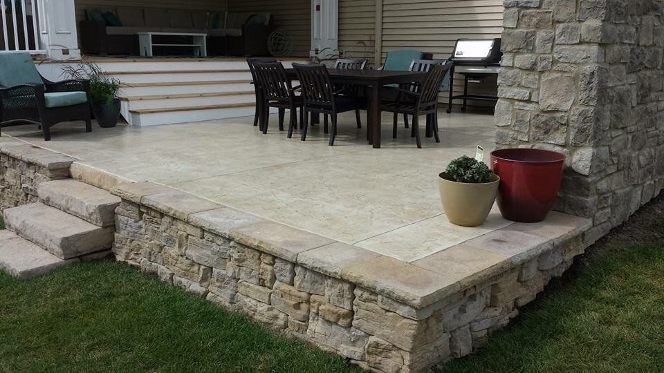 Patio with dark seats and table — Cedar Rapids, IA — Earthworks Concrete