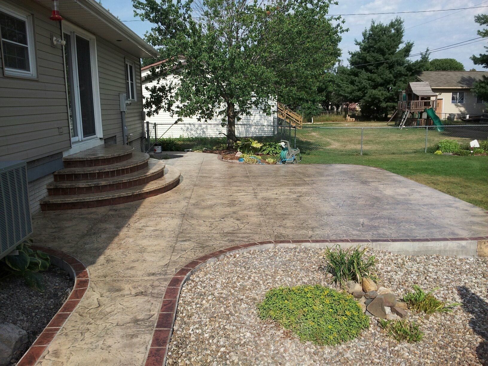 Backyard with stones and plants — Cedar Rapids, IA — Earthworks Concrete