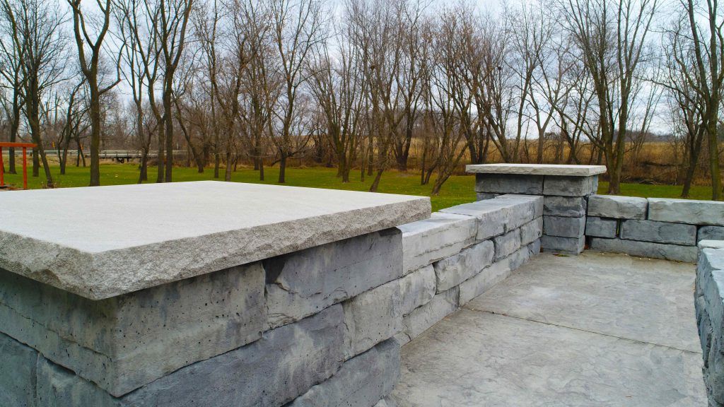 Fancy stone patio with small pillars — Cedar Rapids, IA — Earthworks Concrete