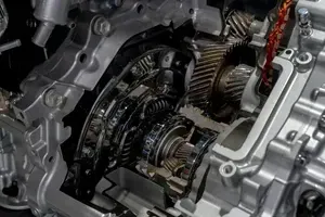 Close-up of a car transmission’s exposed gears and metal housing inside an engine assembly