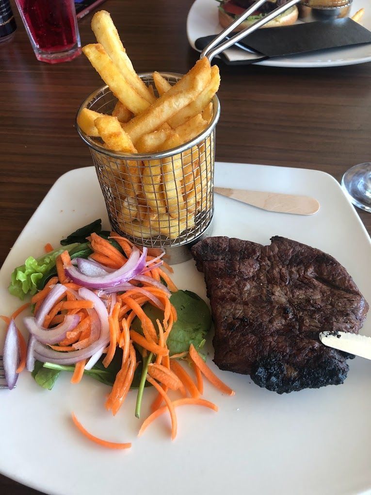 Steak, Fries in a Basket, and Salad on a White Plate — Capricorn Tavern in Taranganba, QLD