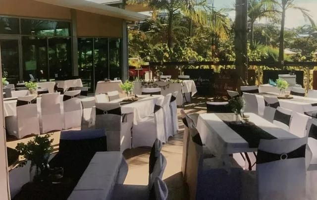 Outdoor Event Tables Set Up With White Chair Covers and Black Accents — Capricorn Tavern in Taranganba, QLD