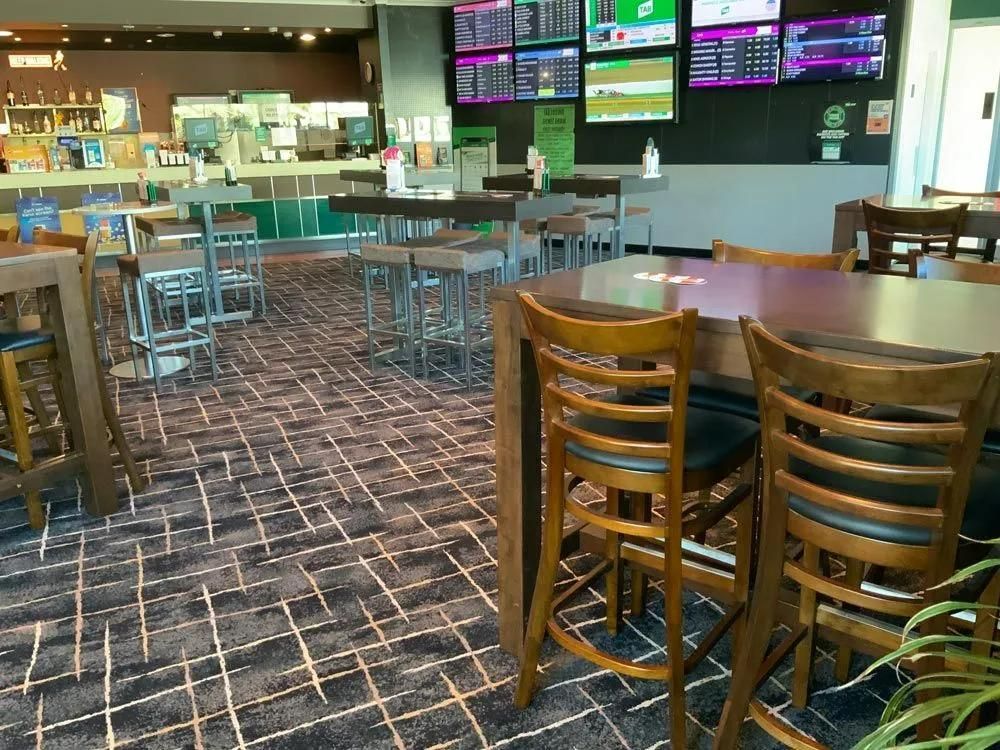 Interior of a Pub With Tables, Chairs, Bar in the Background, Tvs — Capricorn Tavern in Taranganba, QLD