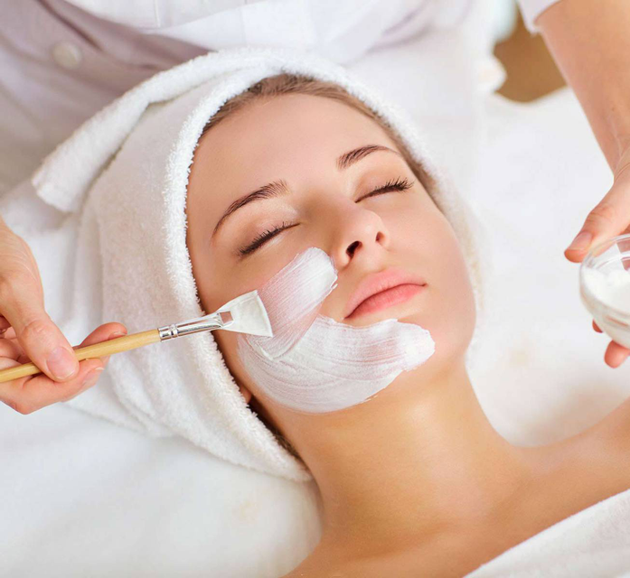 a woman is getting a facial treatment at a spa .