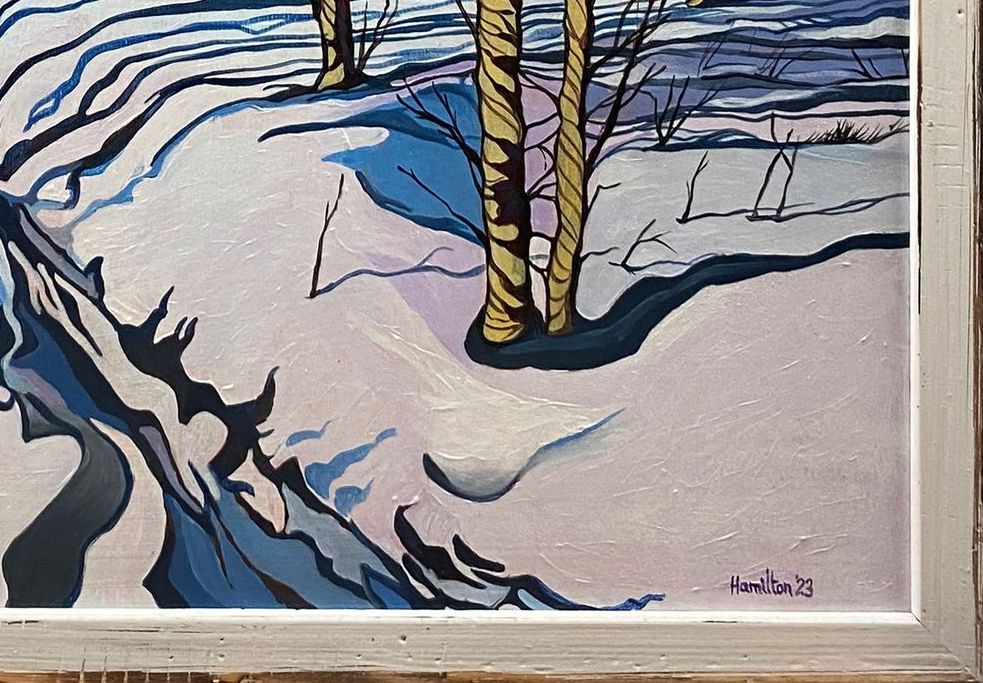 A framed painting of trees in the snow