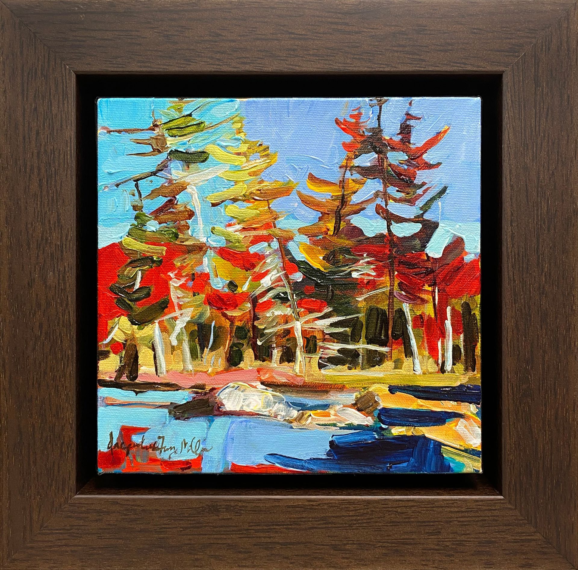 A framed painting of trees and a body of water